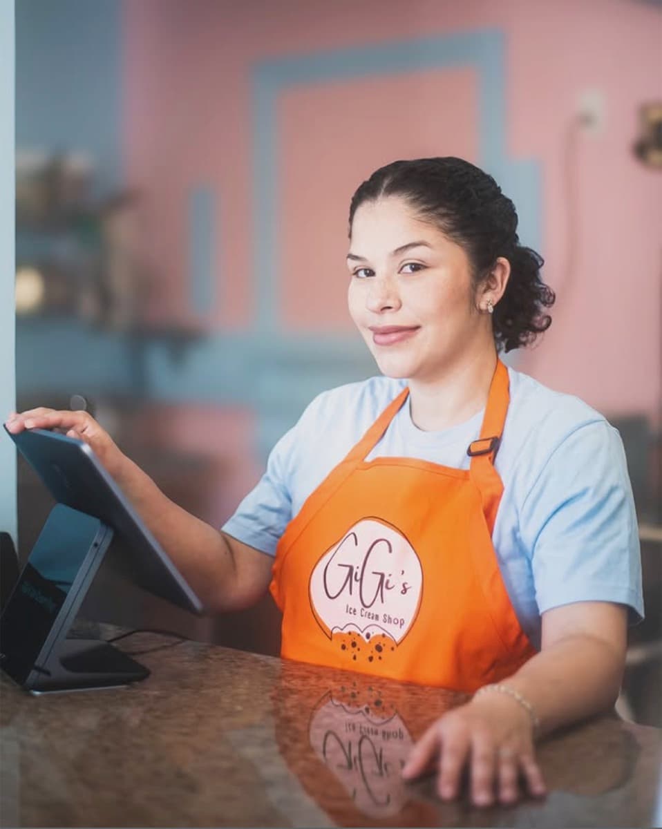 GiGi, owner of GiGi's Ice Cream & Cafe, behind the counter of her shop